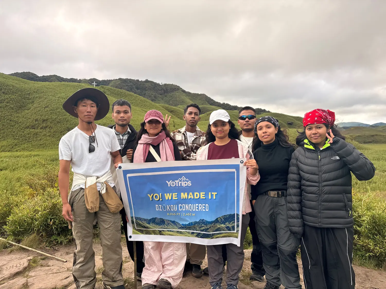 YoTripss crew holding a banner in Dzukou Valley