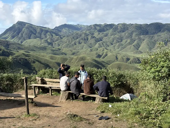 Travellers resting on the Dzukou ridge
